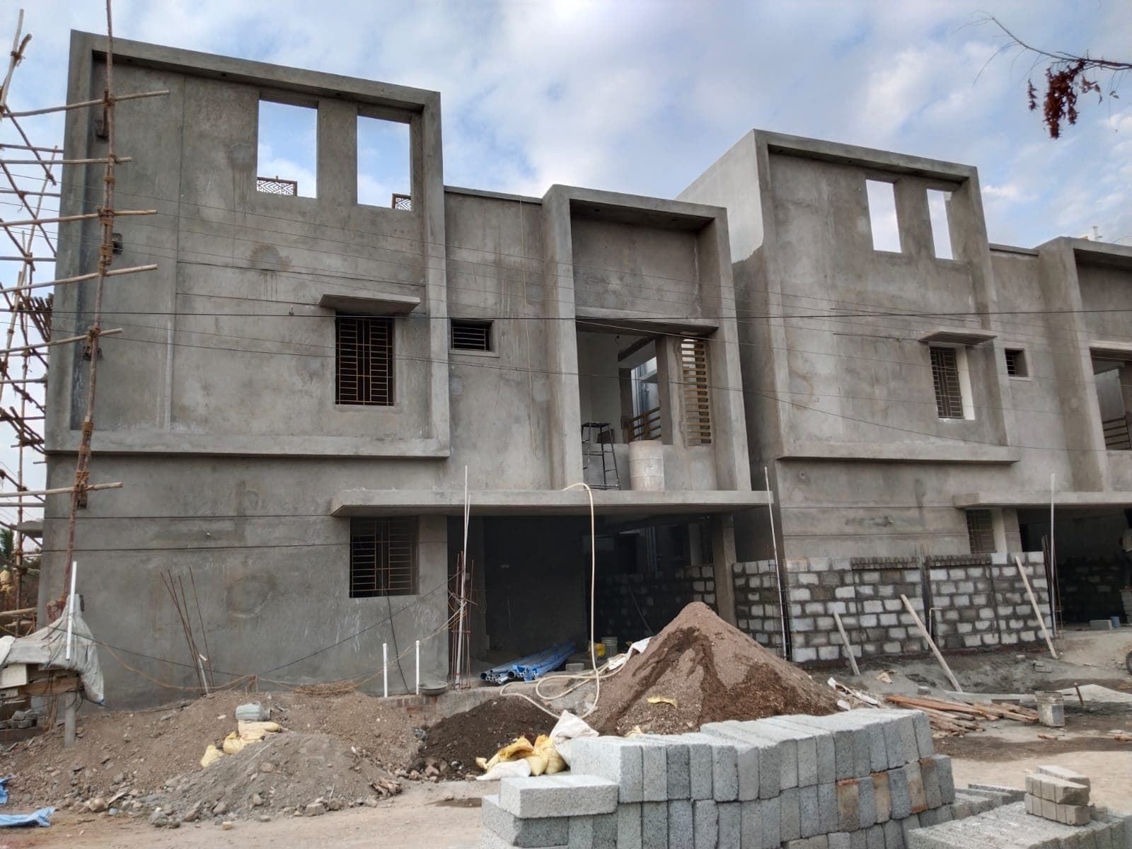 Plastered duplex facade with window openings ahead of exterior finishing