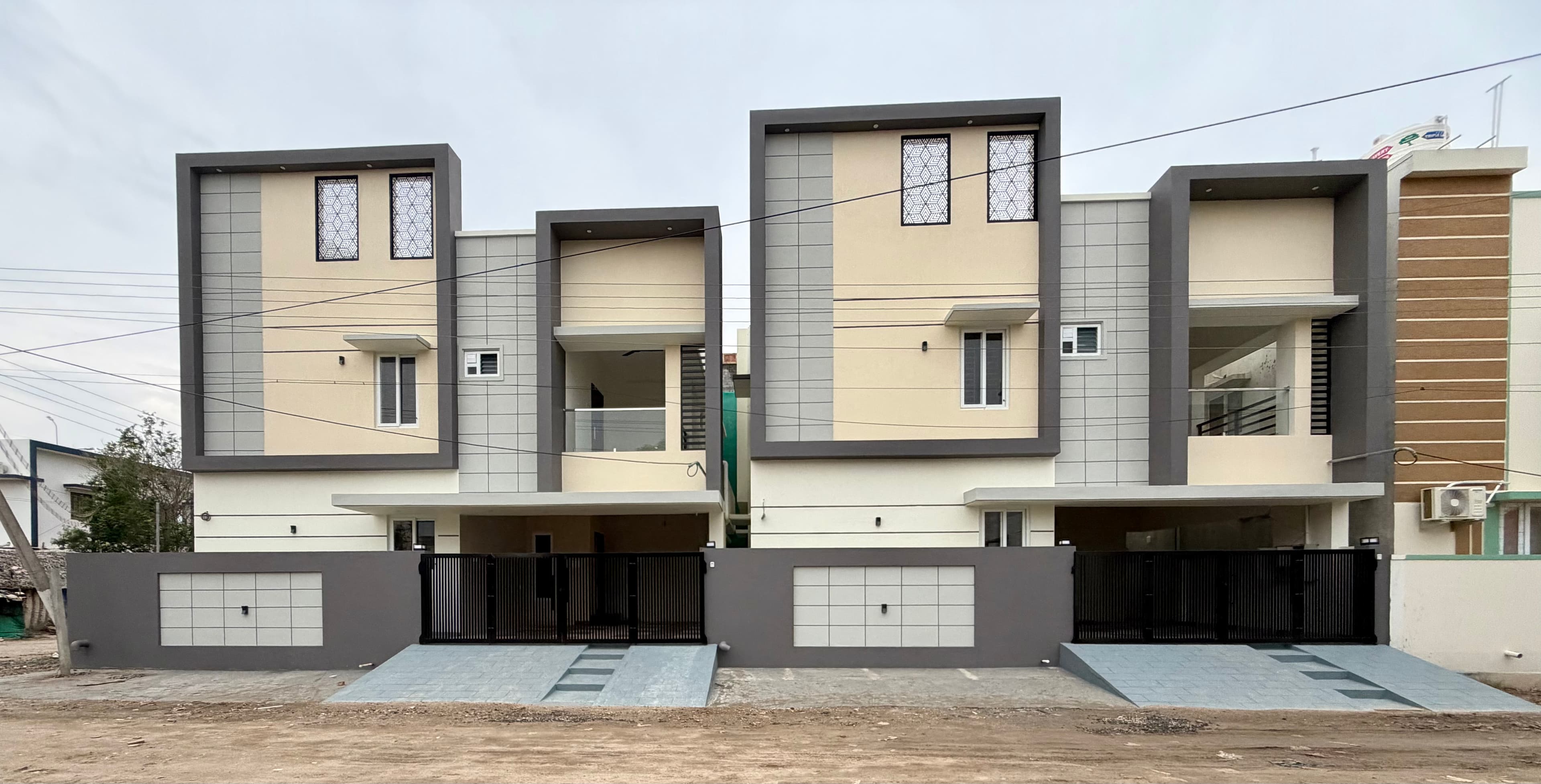 Street-level view along the front of both completed villas