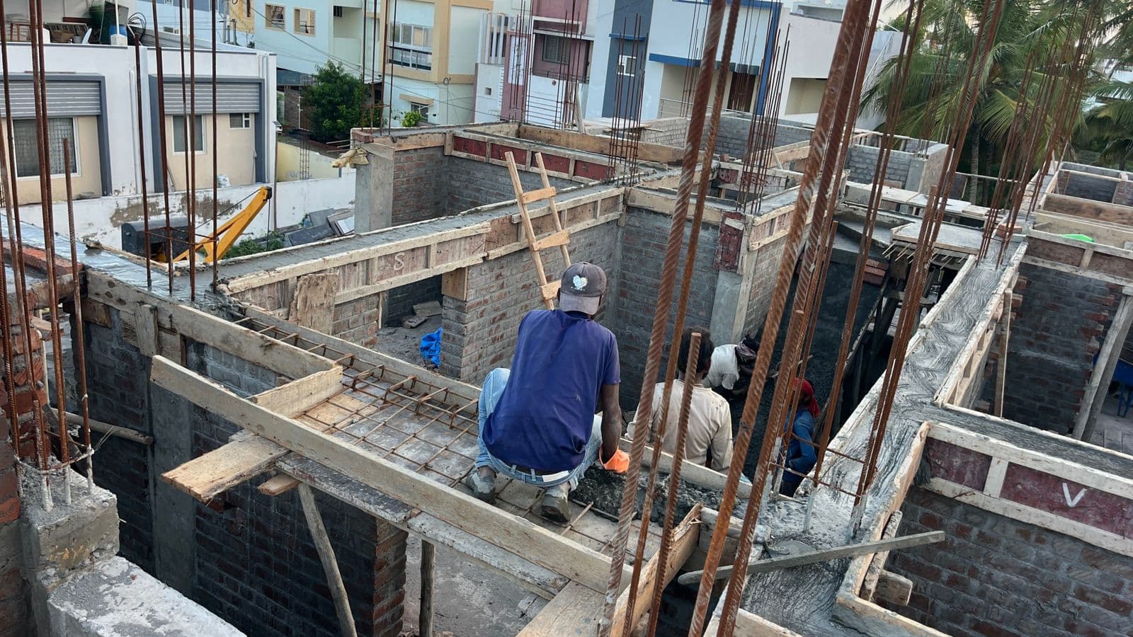 Reinforcement and shuttering for a slab beam, a worker fixing the formwork