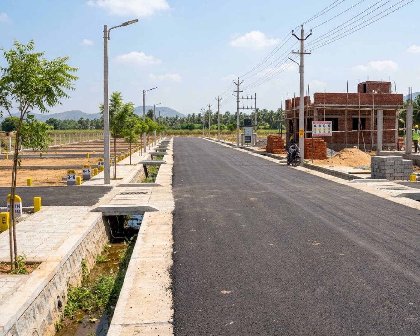 Real-time Tamil Nadu DTCP approved residential plot layout with avenue trees and paved road networks.