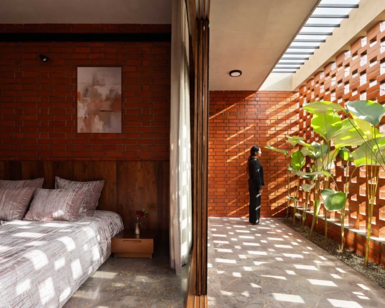 A perforated brick screen casting shade across a modern facade.